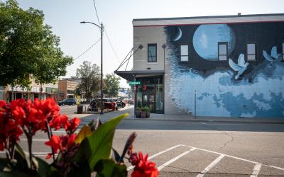 Street view of downtown Loveland Colorado where Aims Loveland campus is located showing building with mural