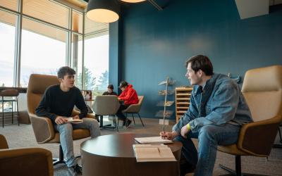 Two students working together at a table in the Learning Commons