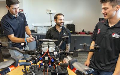 Aims UAS Students working on a drone in a classroom
