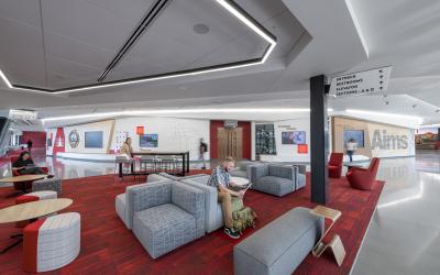 A student reading in the Aims Welcome Center lounge