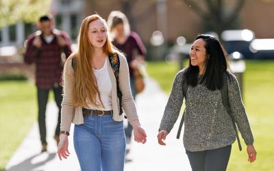 Two transfer students walking on campus