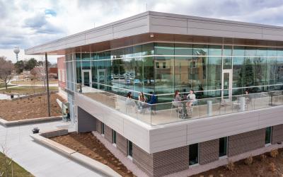 Students sit outside on the deck at the Aims Greeley Campus Welcome Center