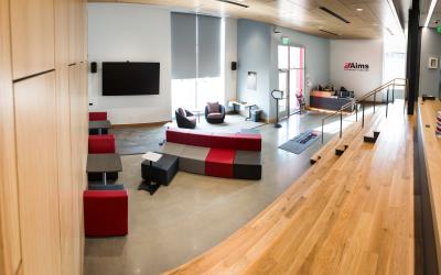 An open concept lounge with couches and chairs in the lobby of the Aims Gateway Building