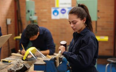 Two students at workbench woodworking