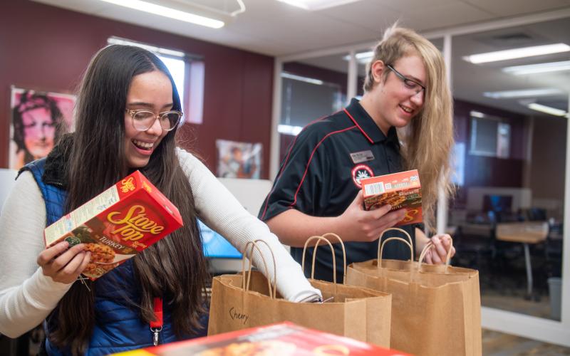 students working to fill Thanksgiving meal kits for distribution