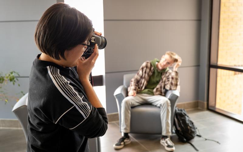 one student taking photo of another student