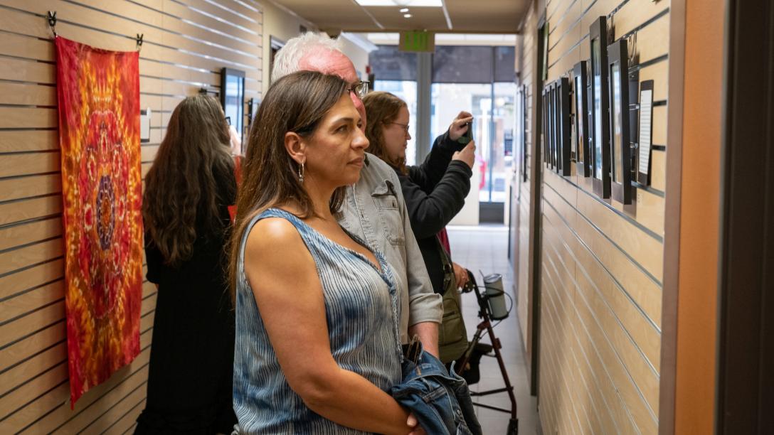 People looking at art at Aims student art show