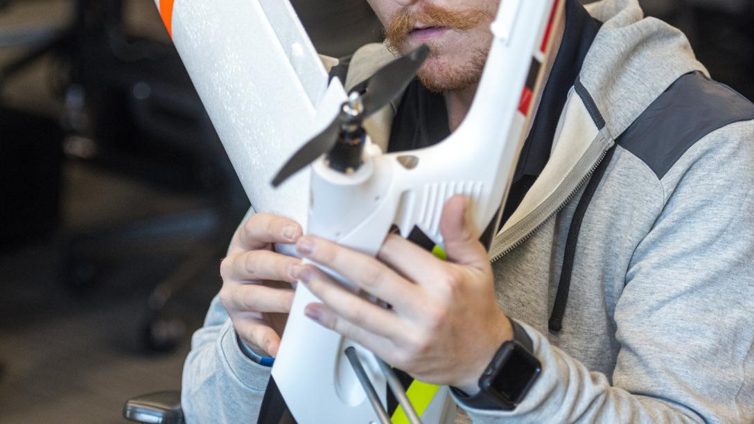 Aims student working in a fixed wing drone aircraft at the Windsor Campus