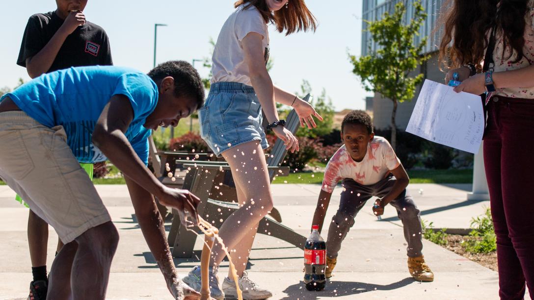 College for kids, group of kids experimenting with Mentos and Diet Coke