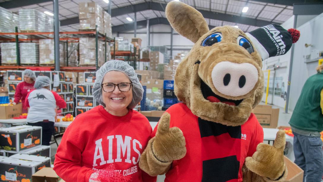 Aims Community College staff member and Arty the Aardvark posing during a Weld County Food Bank charity event