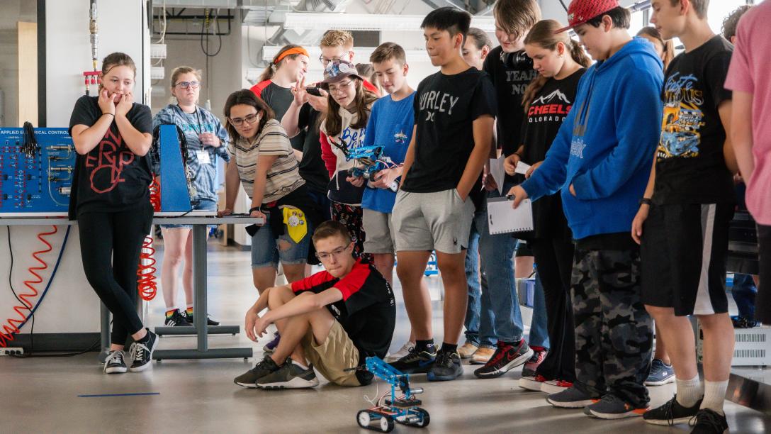 BEST Camp Robotic competition, student watching robot in action