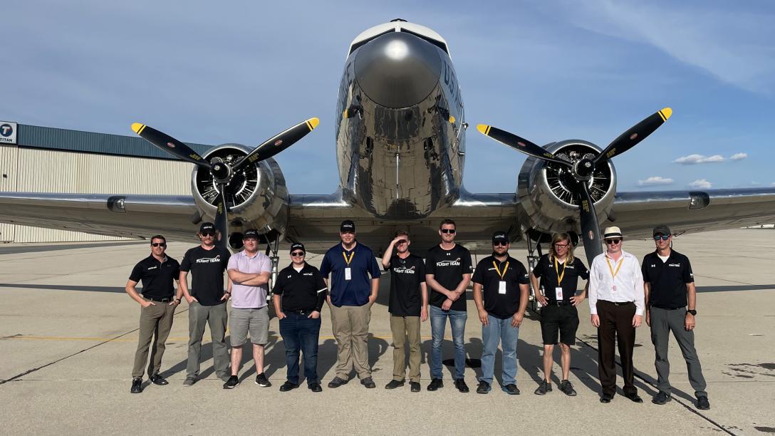 Aims Flight Team posing in front of plane