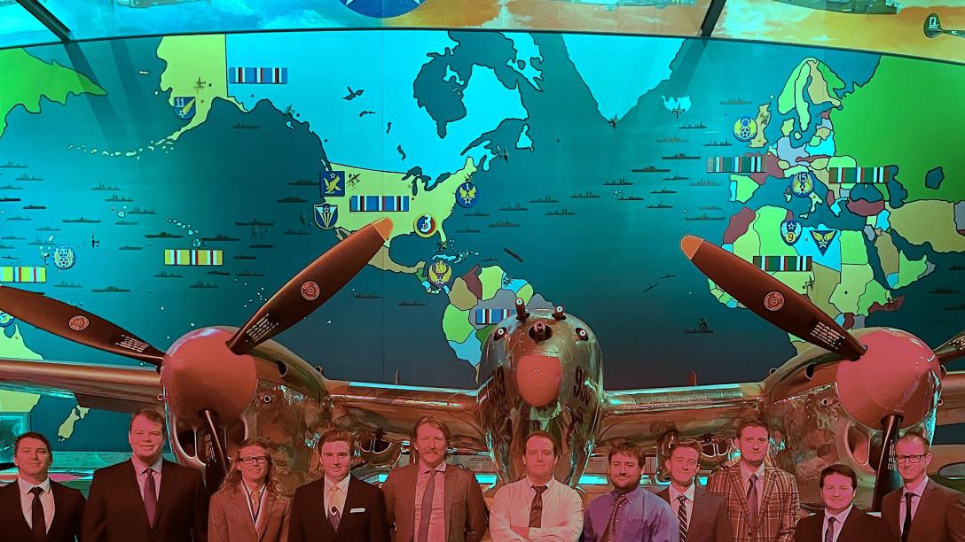 Aims Flight team in front of map