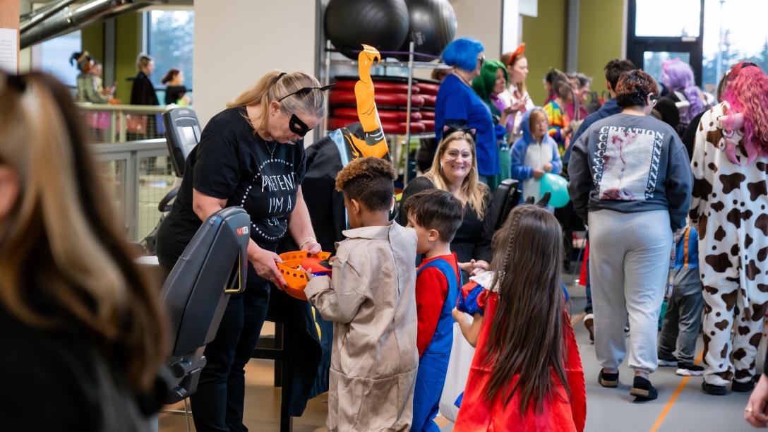 Children trick or treat inside the PERC.
