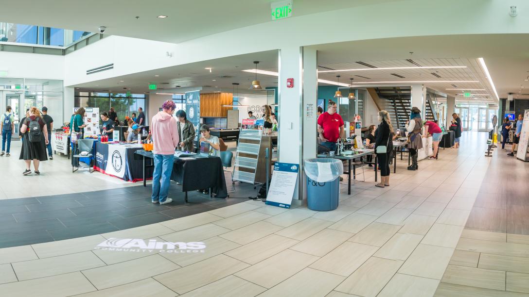 A wide view of the Student Commons main floor with students wandering about