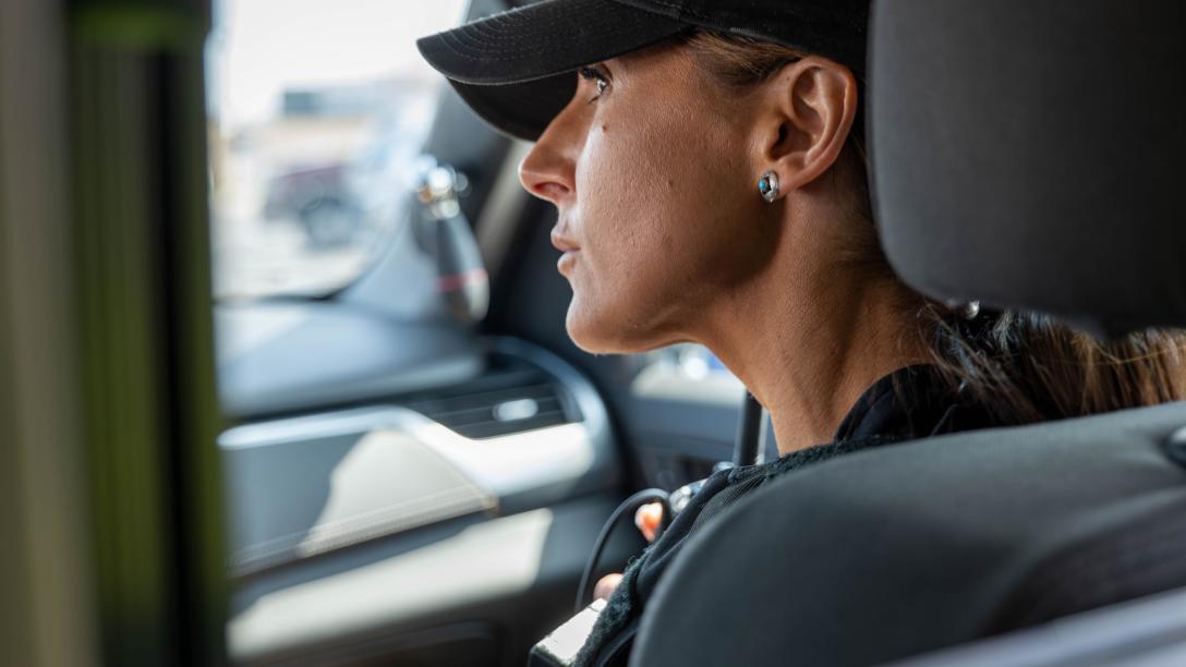 An Aims Peace Officer Academy cadet listening intently during a training exercise inside a vehicle