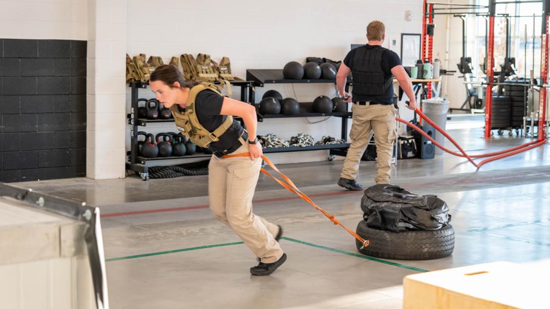 Aims Peace Officer Academy cadets pulling weighted tires during POST physical exam training exercises