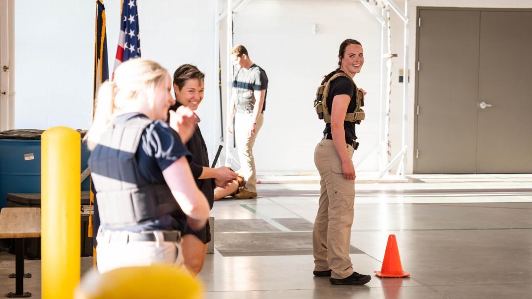 Aims Peace Officer Academy cadets sharing a laugh during a tactical physical training exercise