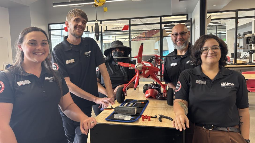 SGA posing with an airplane model on the Windsor campus.