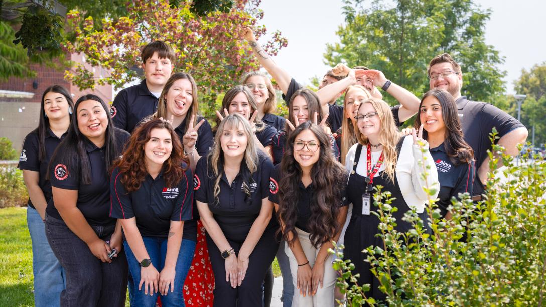 2026 Student Life student leaders doing silly poses in their uniforms.