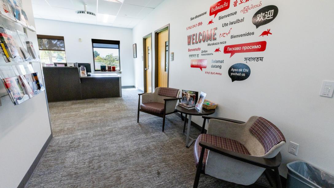 Office space in the Summit Building with two chairs along a wall showing words in multiple languages