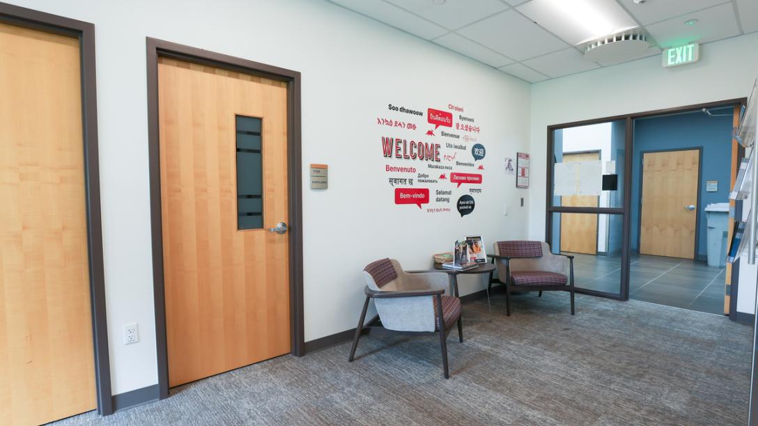 Summit Building interior hallway with gray carpet and two chairs