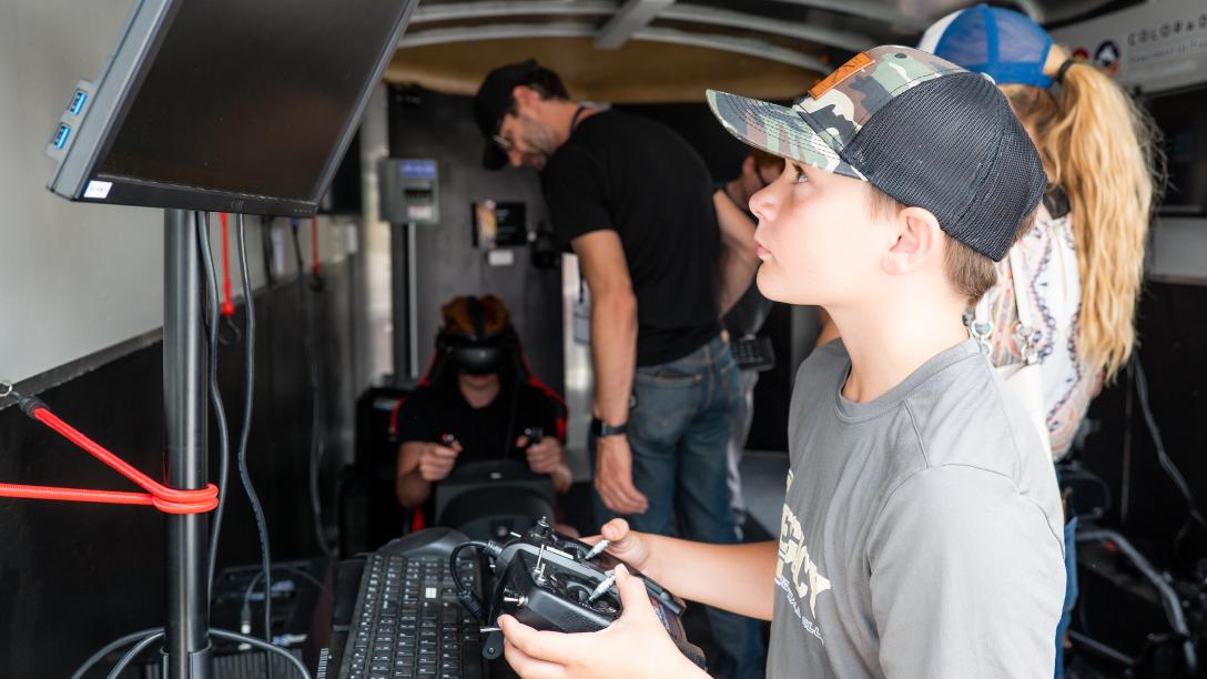 Kids using simulators in the mobile aviation lab
