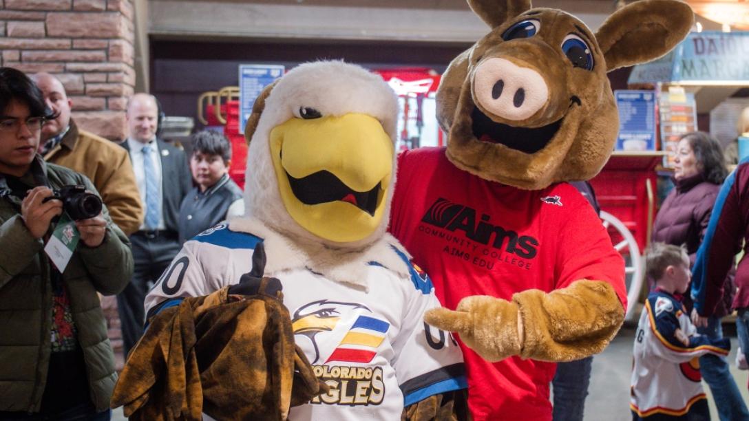 Arty the Aardvark mascot and the Colorado Eagles mascot pose together