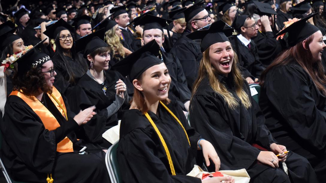 Aims Graduation Crowd of Students in Cap and Gown