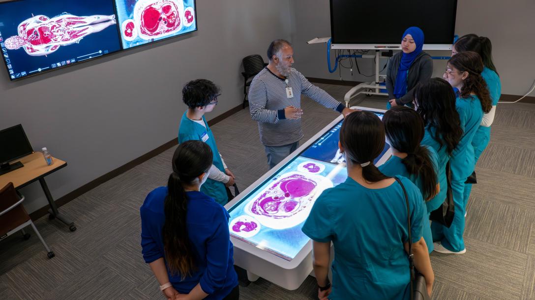 Anatomage table with students and intructor around it