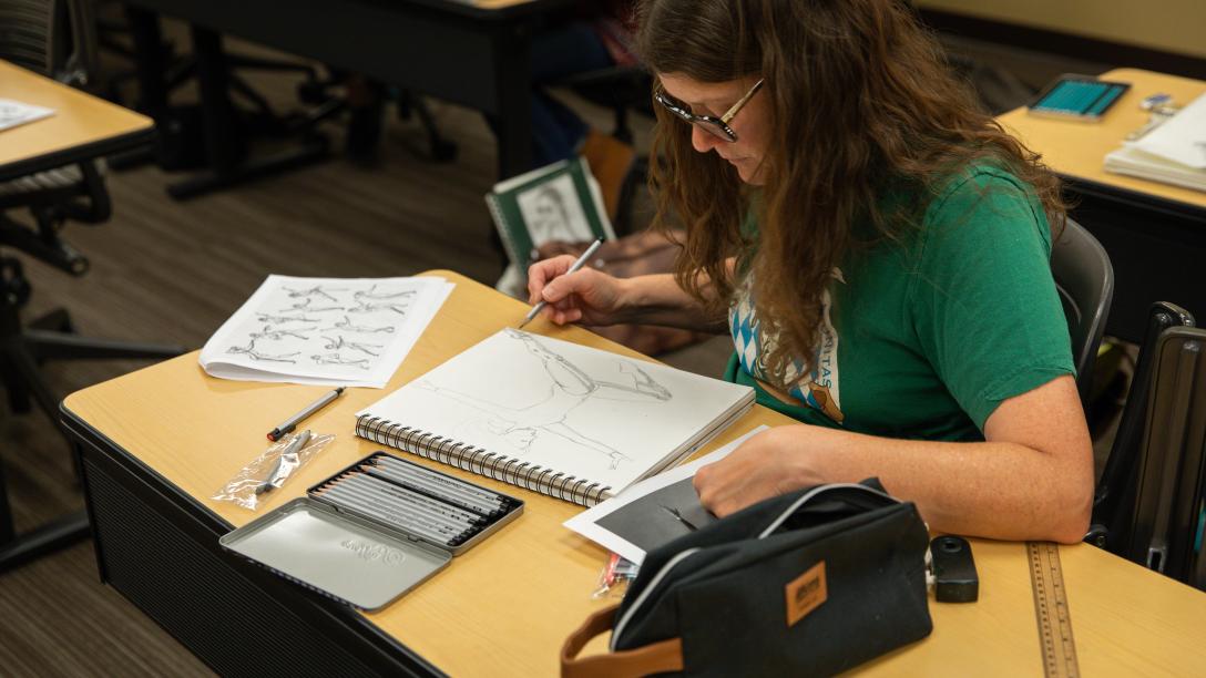 Woman drawing in a class
