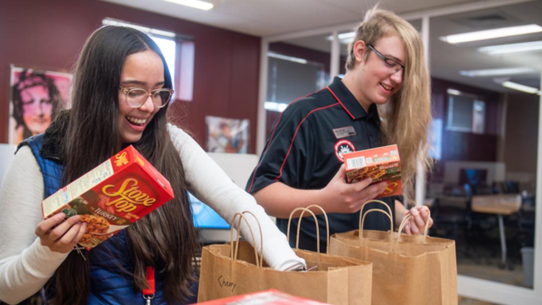 Students bagging Thanksgiving meal kits