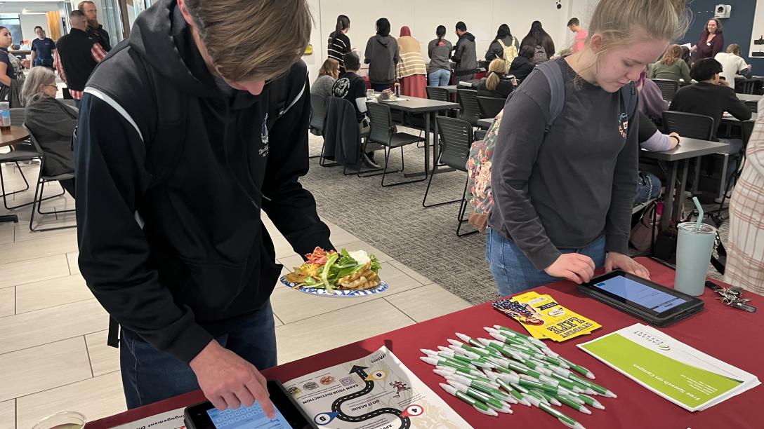 Aims students signing up for event at table