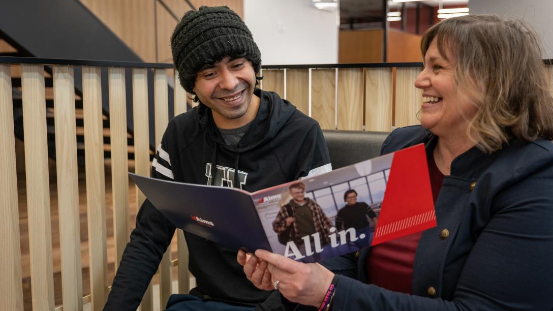 Admission Councilor showing student information in a book