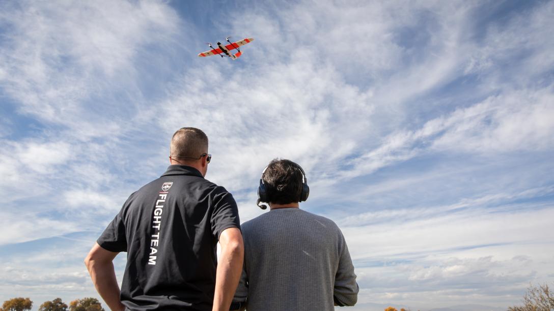 flying a drone in a blue sky with clouds