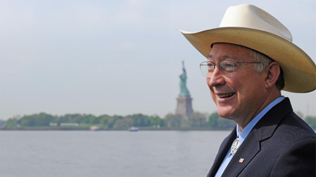 Ken Salazar with Statue of Liberty in the background