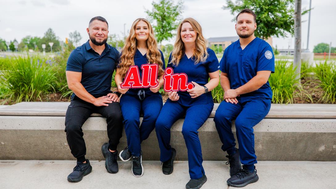 Lozano Family photo holding "All in" sign