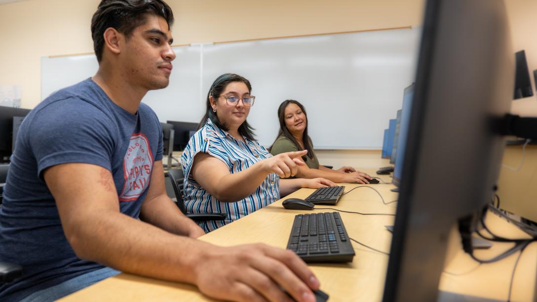 3 students on computers in Aims computer lab