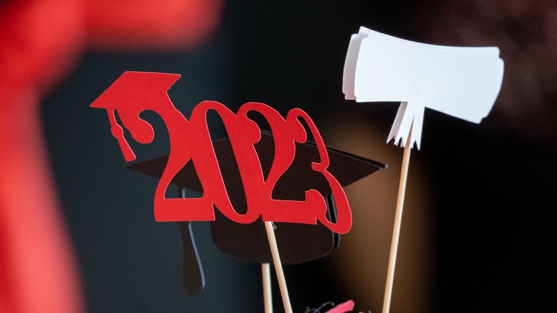Cup with confetti and 2023 graduation decorations