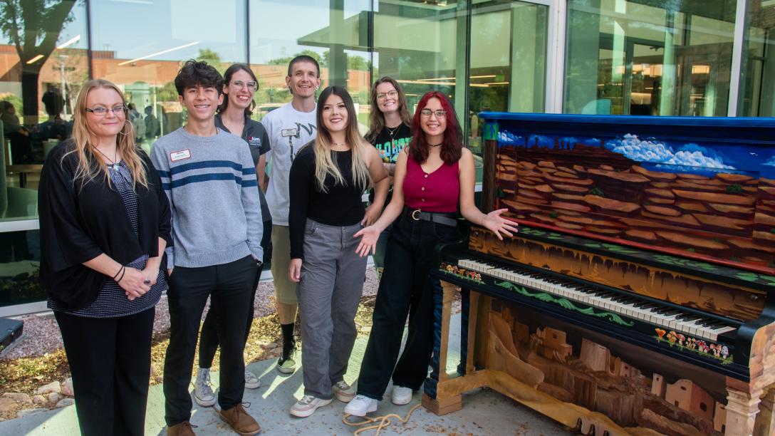 Aims student leaders at with a painted piano on campus