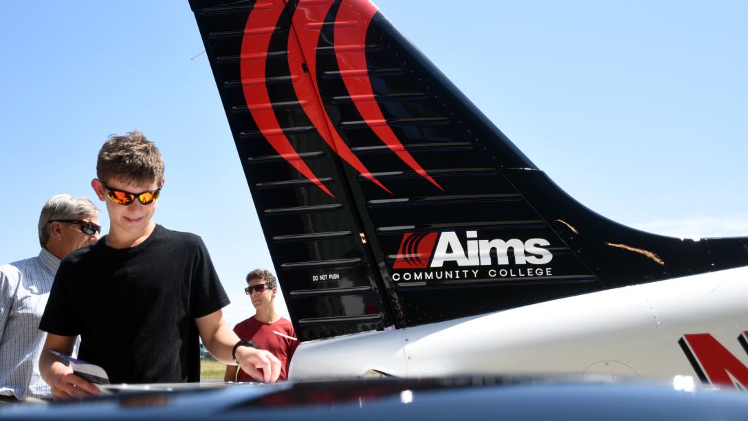 People looking at Aims Airplanes