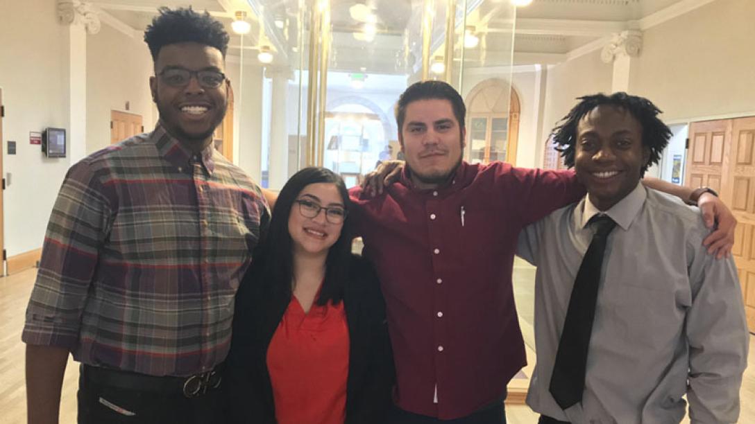 Four students smiling at camera