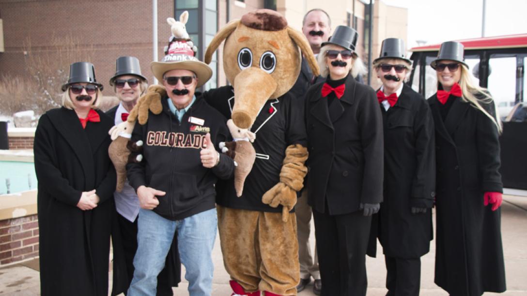 Group of men with Aardvark mascot