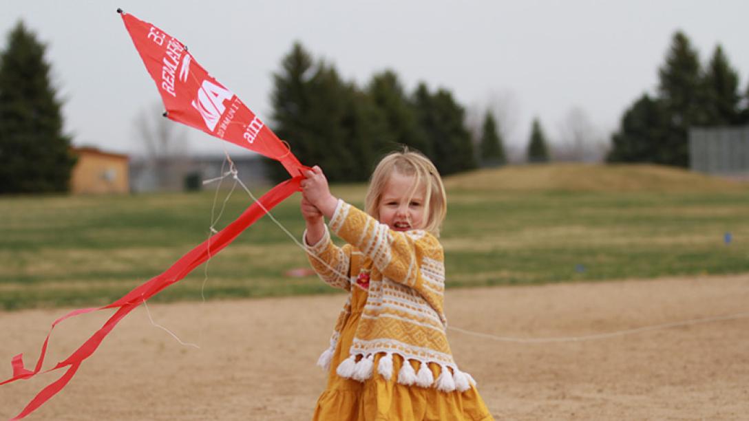 Young girl with red kite