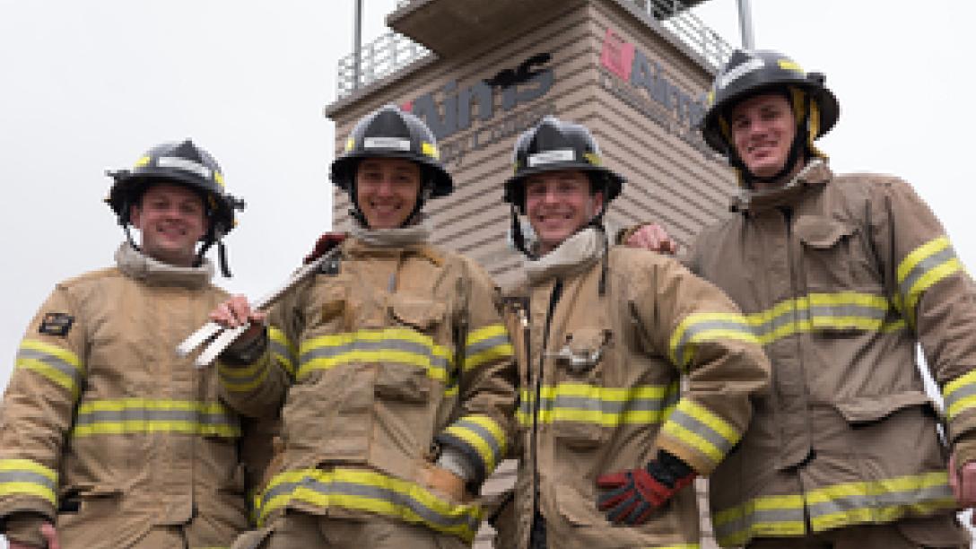 Four firefighters smiling at camera