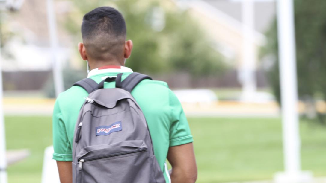 Man with backpack walking away
