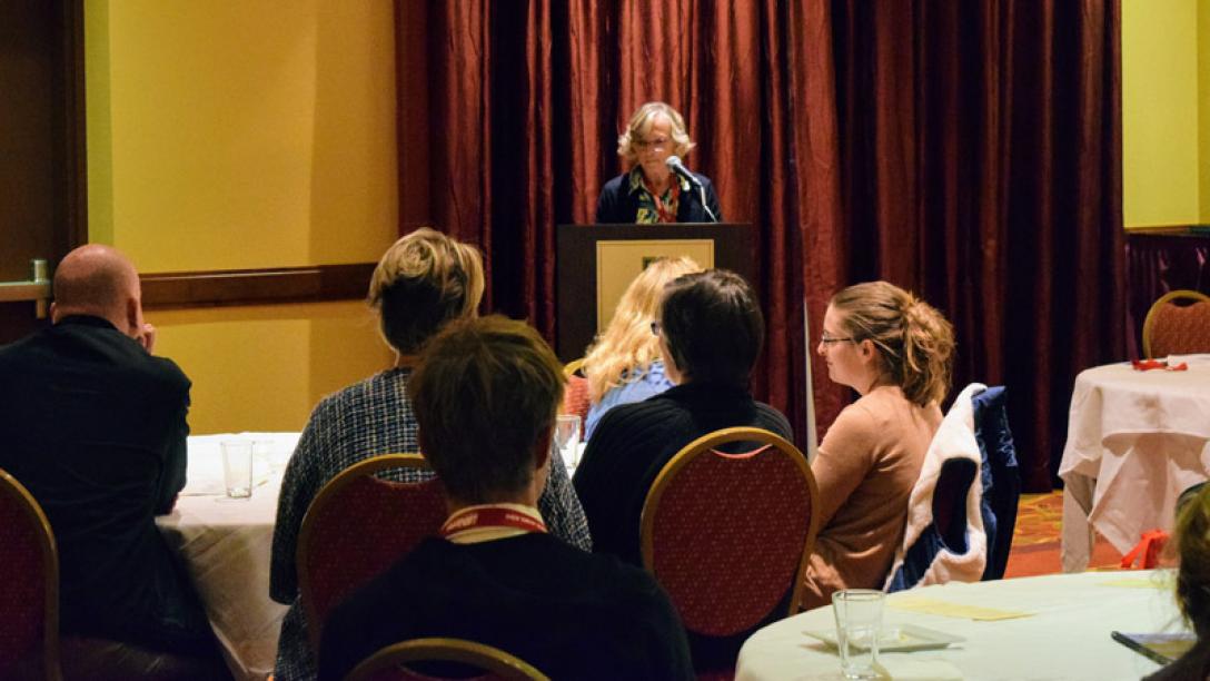 Woman speaking at podium