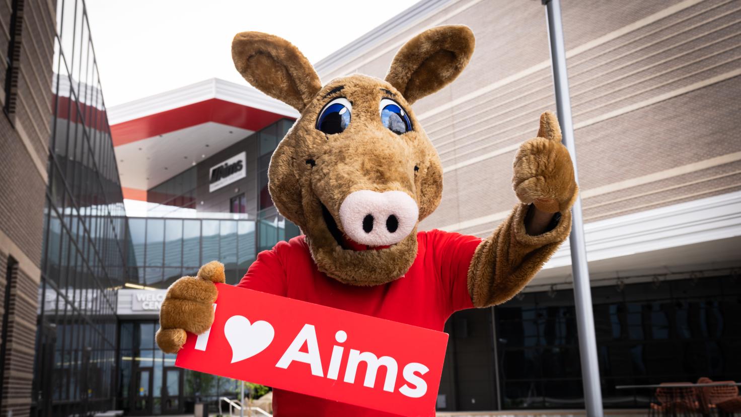 Arty with I love Aims Sign