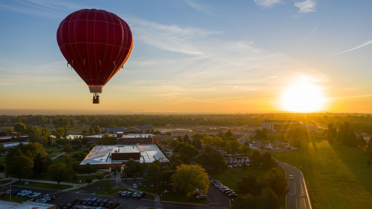 An aerial view of a hot air balloon over the Aims Community College campus