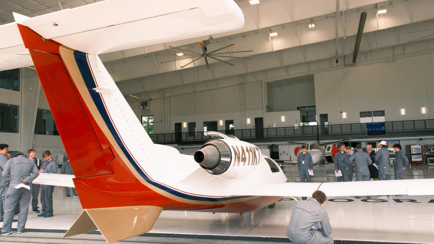  Aircraft Maintenance students inspect the Maverick TwinJet 1500